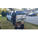 The two children petting the K-9 dog while the Officer watches intently